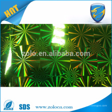 Laser holographic void label material with custom pattern